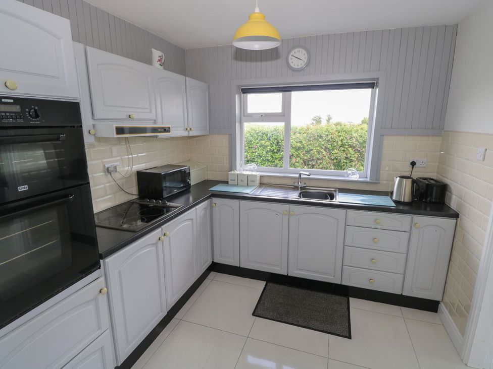 A kitchen with appliances and window at Tí Chonaill in 