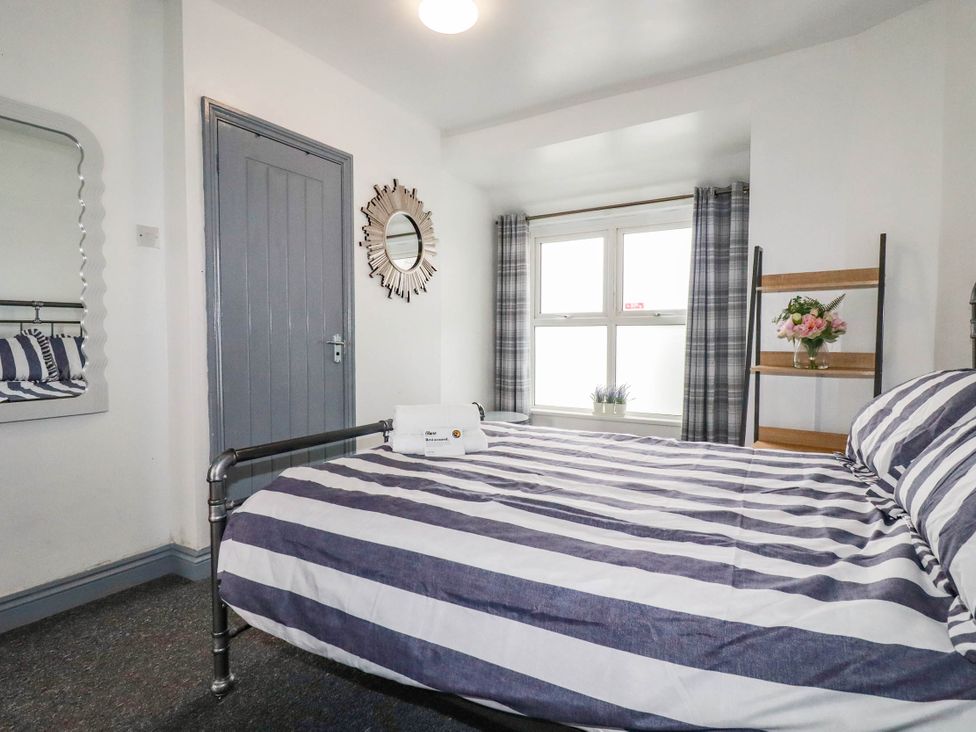 A bedroom with a bed and a shelf at Shoreline Studio Room No.5 Newquay