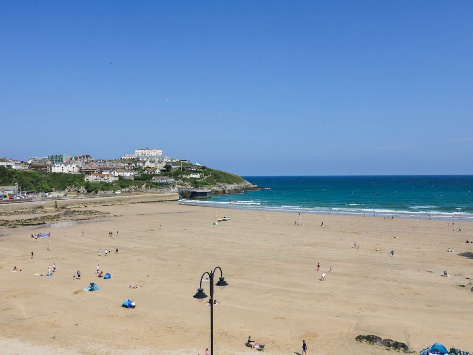 A beach with people walking and enjoying the sun at Shoreline Studio Room No.5 in Newquay
