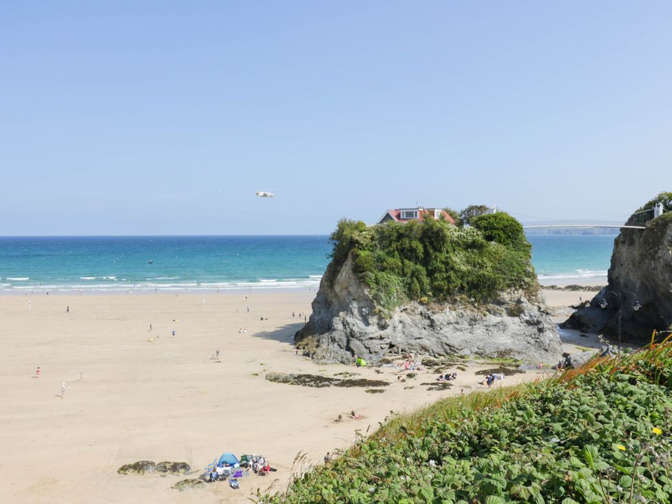 A beach scene with people and rocks at Shoreline Studio Room No.5 Newquay