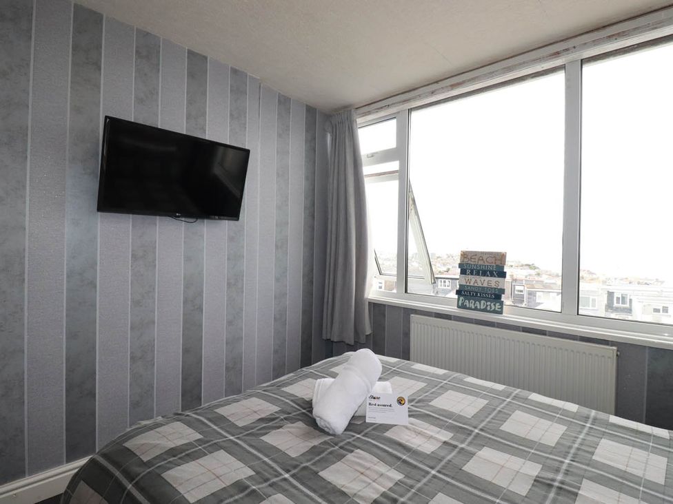 A bedroom with a bed and television at Shoreline Studio No.7 Newquay