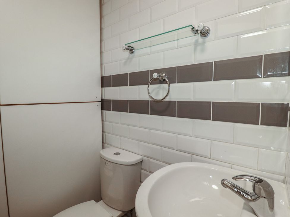 A bathroom with a toilet and sink at Shoreline Apartment No.8 in Newquay
