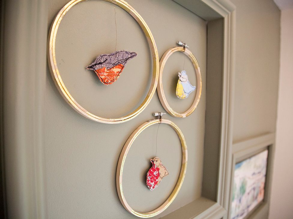 Decorative hoops with painted birds at Snug Cottage in Honley