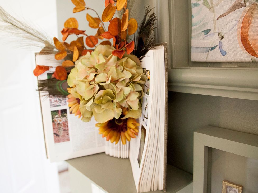 A flower arrangement on a book in Snug Cottage in Honley