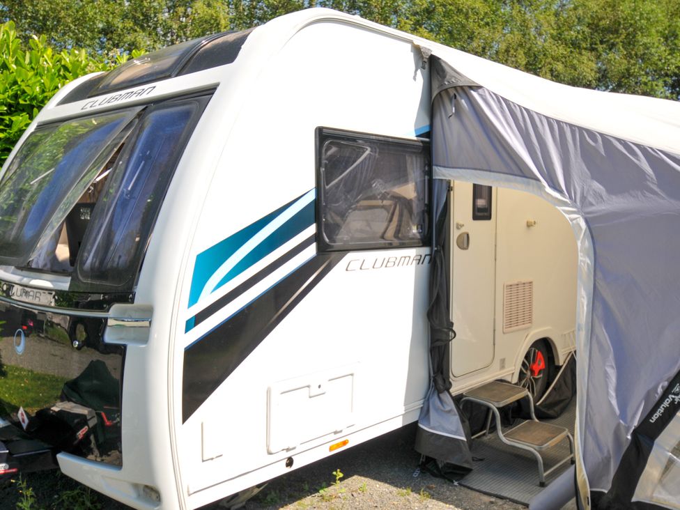 A caravan with an awning and steps at Caravan in Dolton