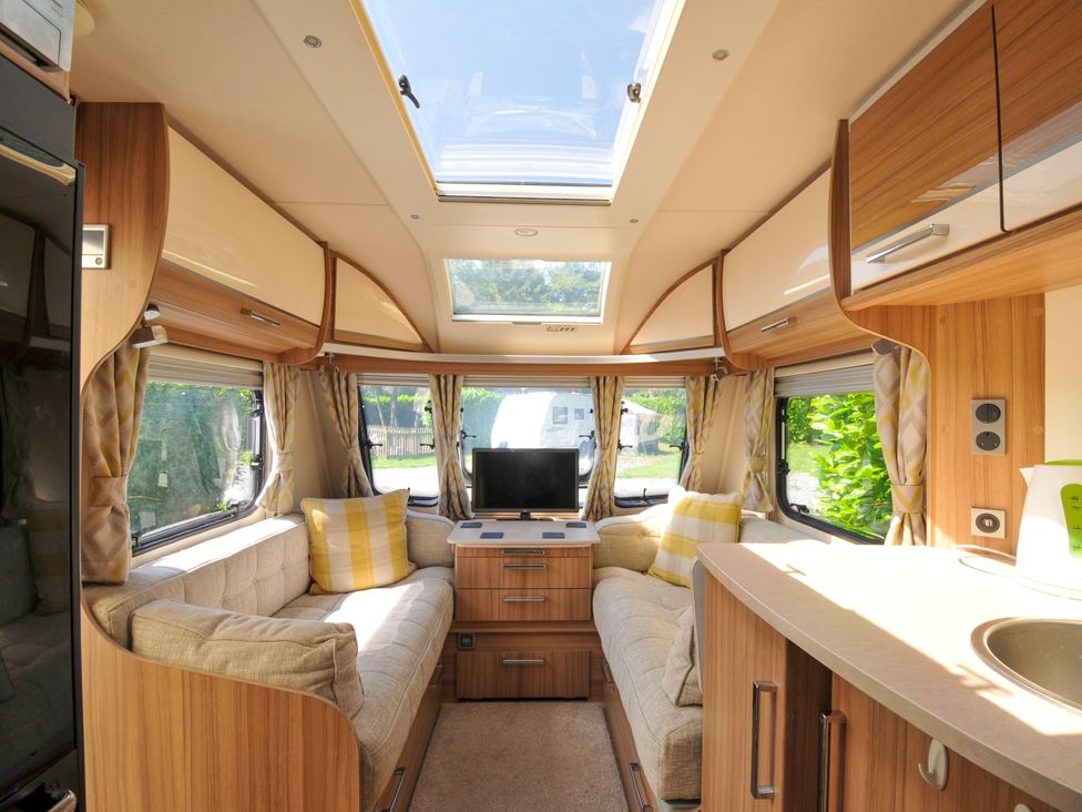 A living room with a couch and television in Caravan Dolton