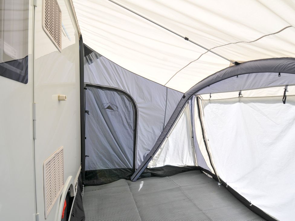 An interior view of a caravan with a tent structure at Caravan in Dolton