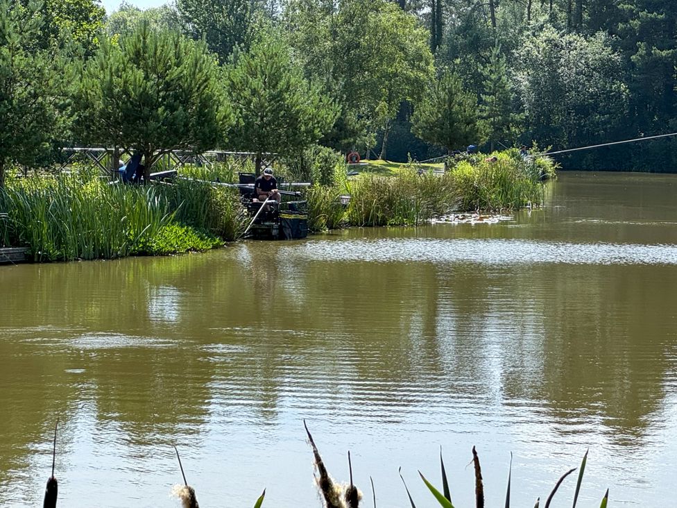 A fishing scene by a lake with people fishing at a nature area in Dolton