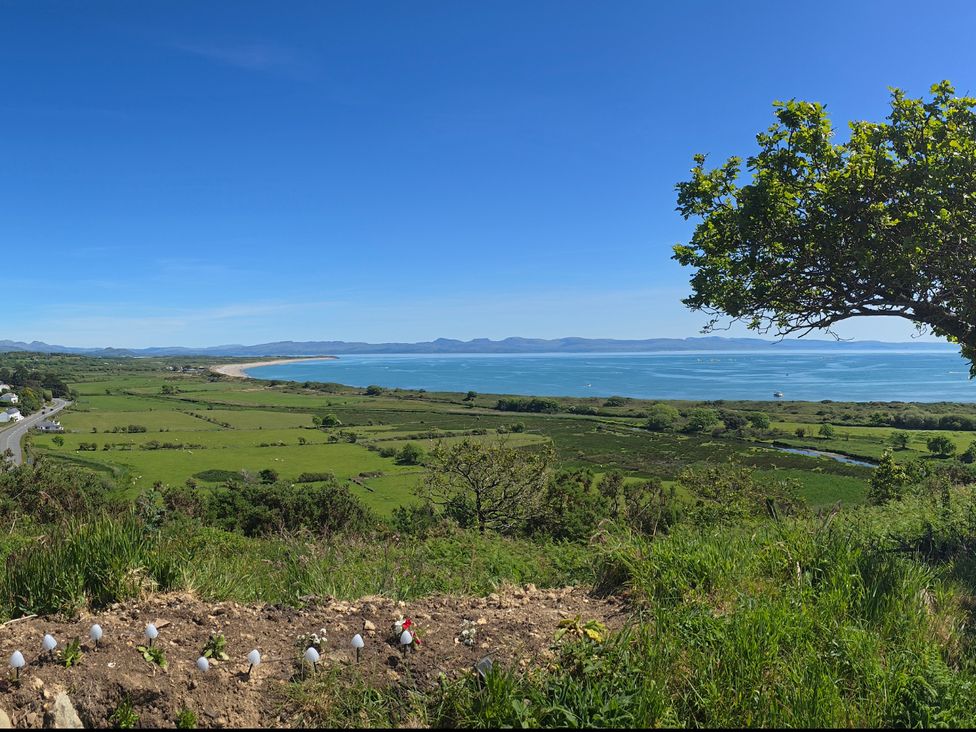 A view of the ocean and landscape at Cwt Bugail Pwllheli