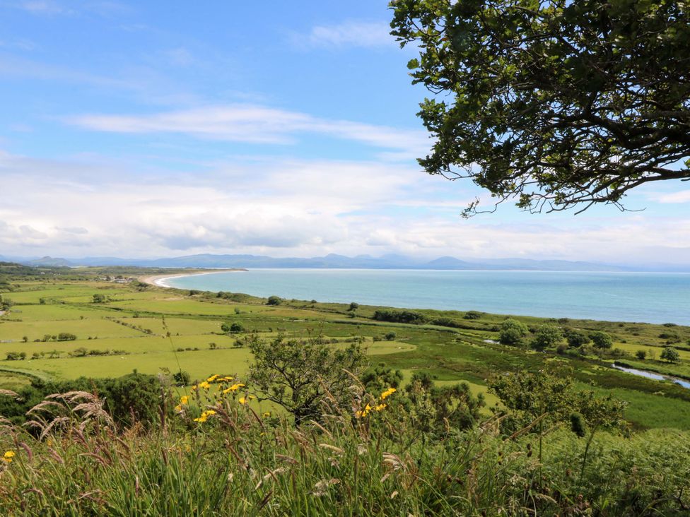 A coastal landscape with fields and sea at Cwt Bugail Pwllheli