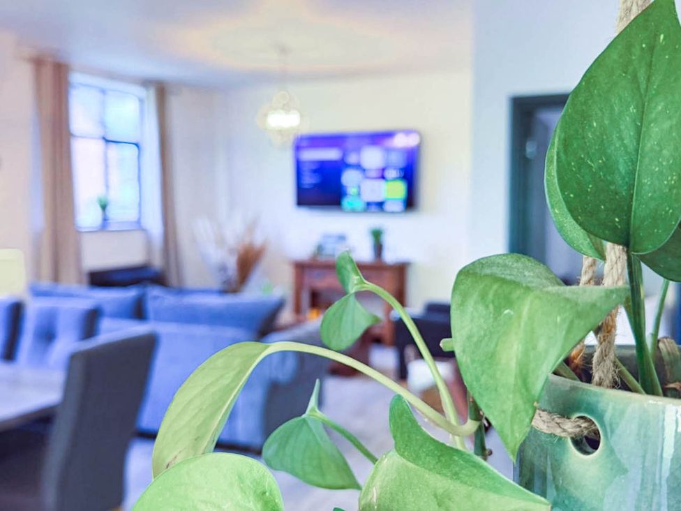 A living room with a television and sofa at Stunning Retreat in the Heart of Matlock Bath, Matlock Bath near Matlock