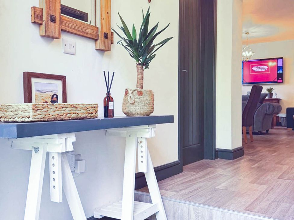 An entryway with a console table and decorative items at Stunning Retreat in the Heart of Matlock Bath