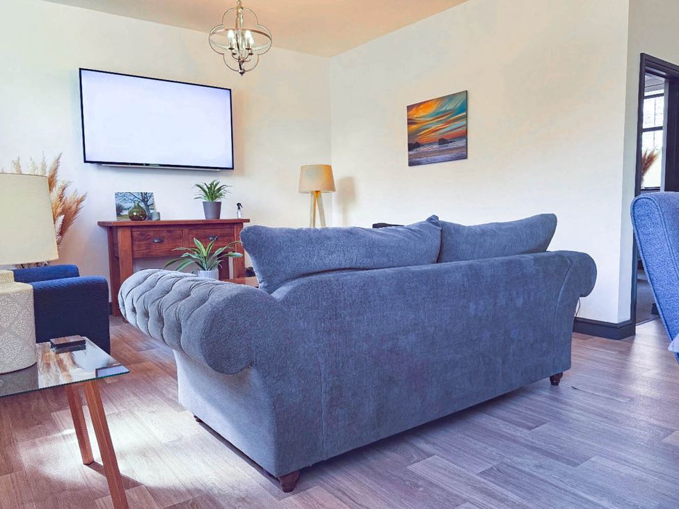 A living room with a sofa and television at Stunning Retreat in the Heart of Matlock Bath near Matlock