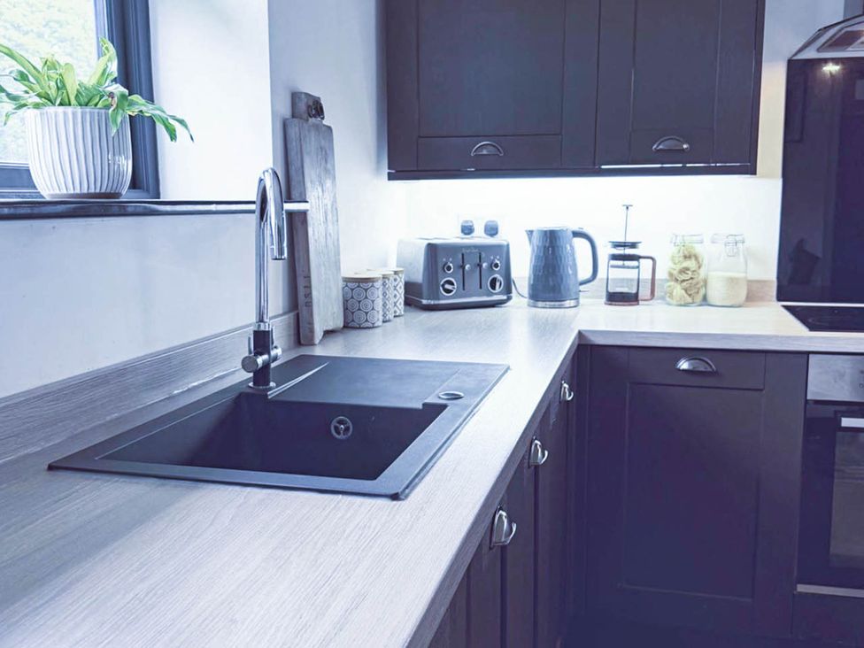 A kitchen containing a sink, kettle, toaster, coffee maker, and storage jars at Stunning Retreat in the Heart of Matlock Bath