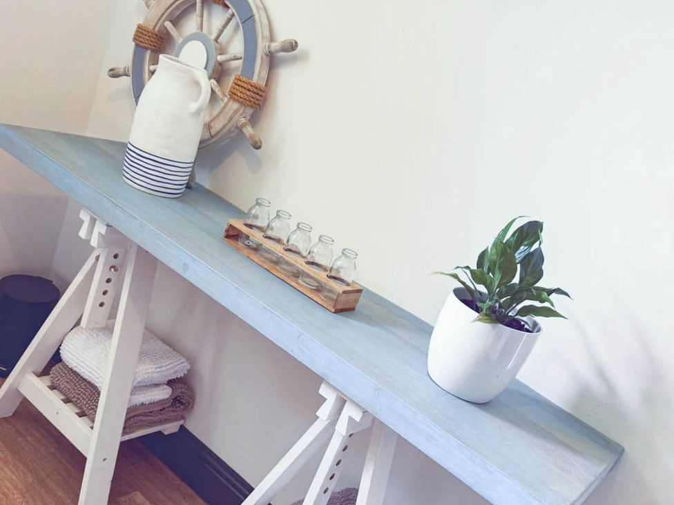 A table with a plant and pitcher at Stunning Retreat in the Heart of Matlock Bath