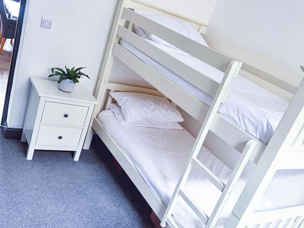 A bedroom with a bunk bed and nightstand at Stunning Retreat in the Heart of Matlock Bath, Matlock Bath near Matlock
