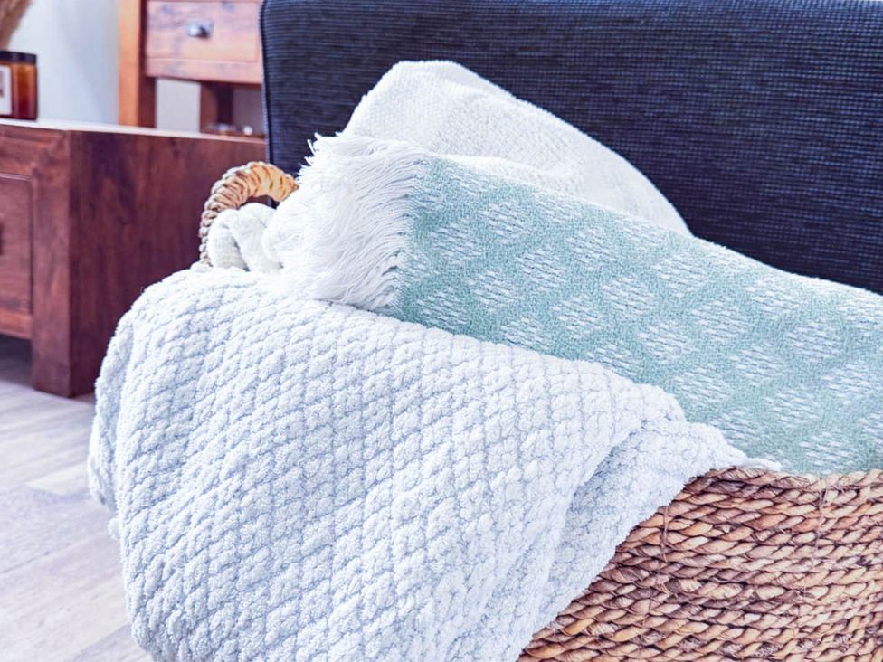 A basket with blankets in a living room at Stunning Retreat in the Heart of Matlock Bath near Matlock