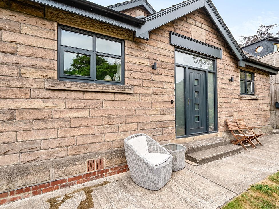 An outdoor area with stone house and seating at Stunning Retreat in the Heart of Matlock Bath, Matlock Bath near Matlock