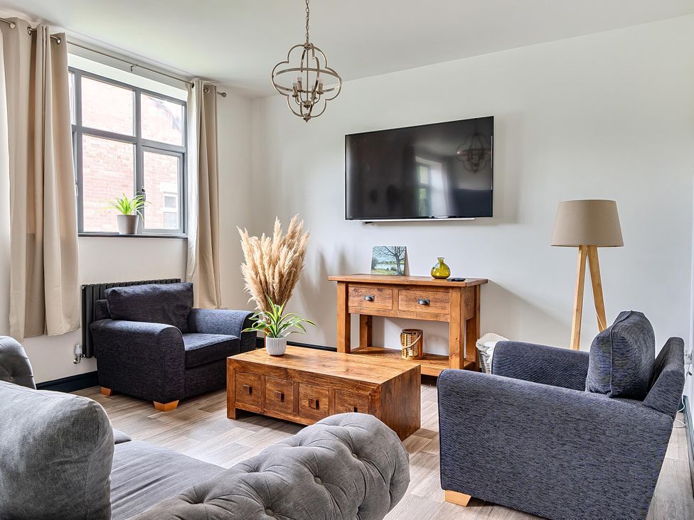 A living room with a sofa, coffee table and television at Stunning Retreat in the Heart of Matlock Bath