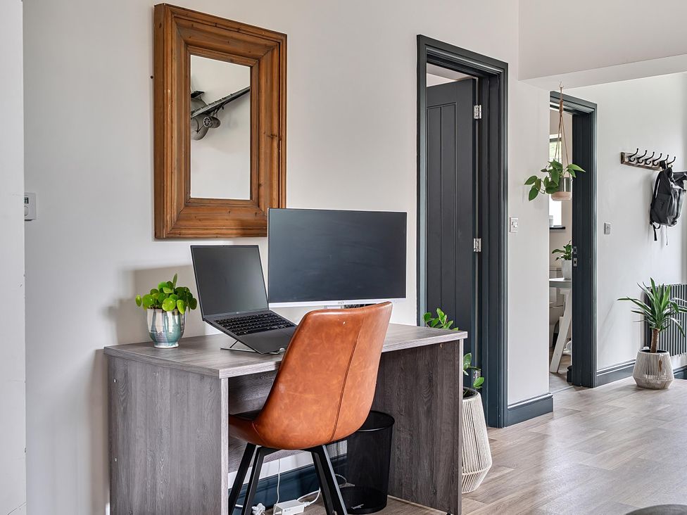 A home office with a desk and computer monitor at Stunning Retreat in the Heart of Matlock Bath
