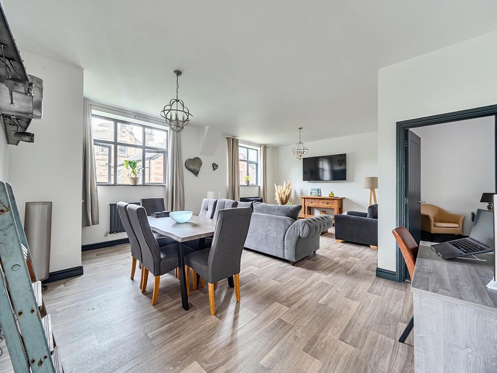 A living room with a table and chairs and a sofa at Stunning Retreat in the Heart of Matlock Bath Matlock Bath