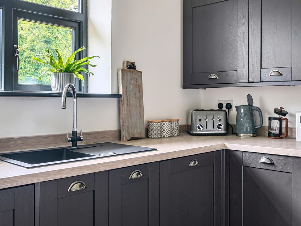 A kitchen with a sink and appliances at Stunning Retreat in the Heart of Matlock Bath, Matlock Bath near Matlock