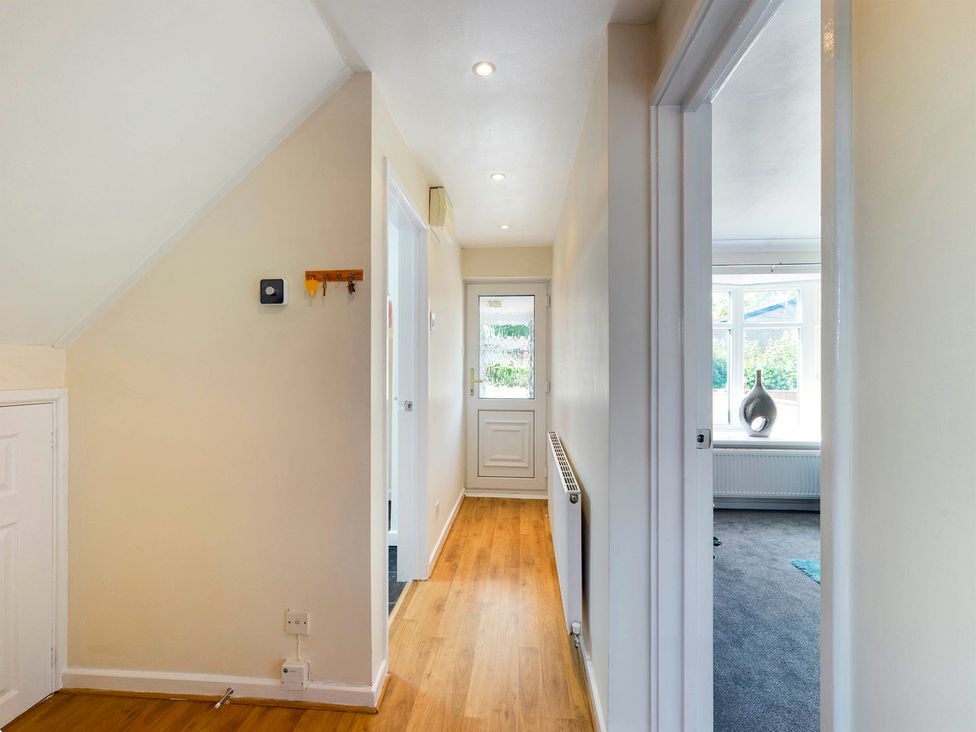 A hallway with door and coat hook at Tranquil Telford Retreat - 3 Bedroom House in Telford