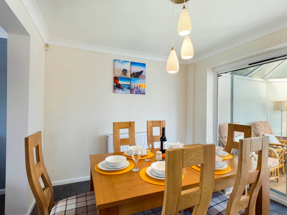 A dining room with a table set for dinner at Tranquil Telford Retreat - 3 Bedroom House in Telford
