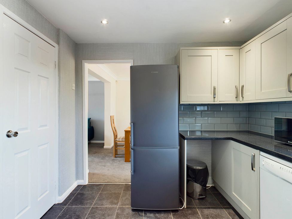 A kitchen with a refrigerator and microwave at Tranquil Telford Retreat - 3 Bedroom House Telford
