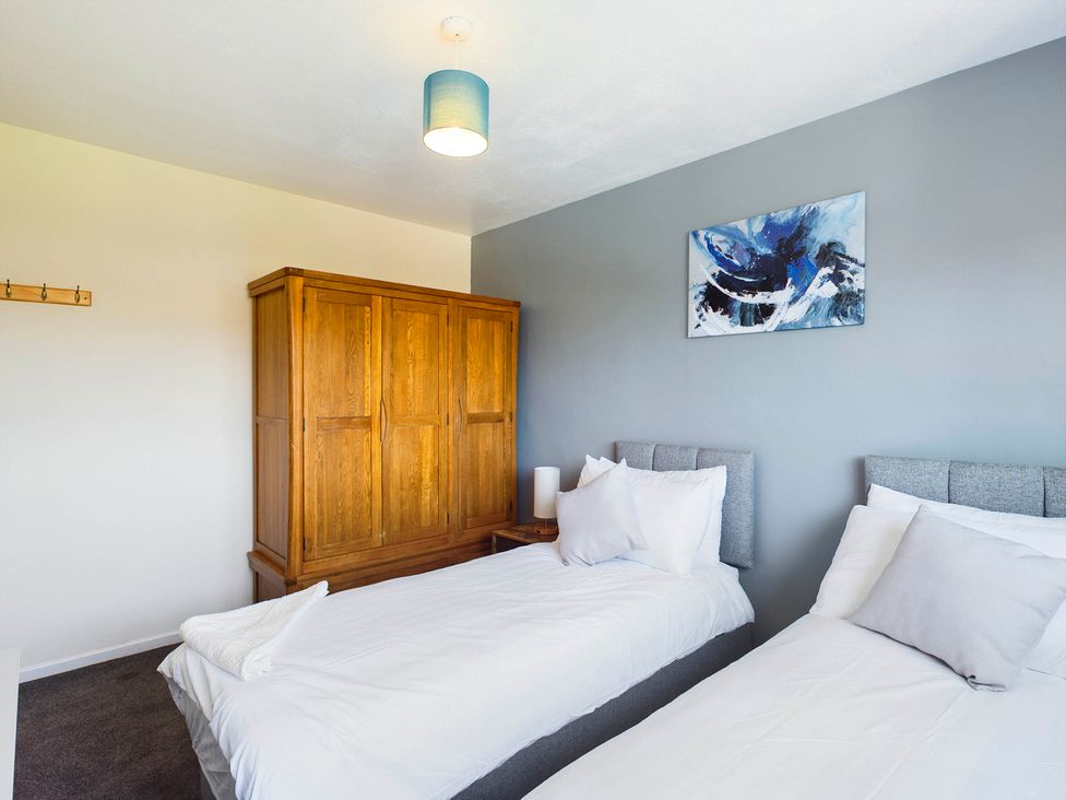 A bedroom with two beds and a wardrobe at Tranquil Telford Retreat - 3 Bedroom House, Telford
