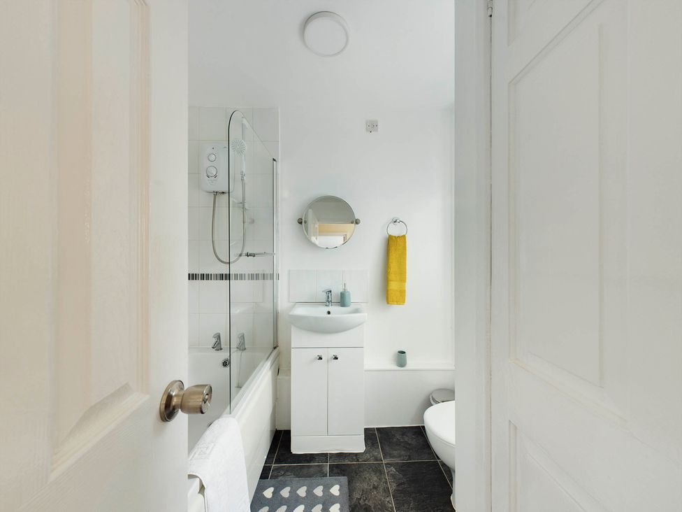 A bathroom with a shower, bathtub, and sink at Tranquil Telford Retreat - 3 Bedroom House Telford