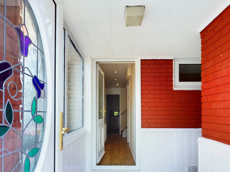 A hallway with a stained glass front door at Tranquil Telford Retreat - 3 Bedroom House Telford