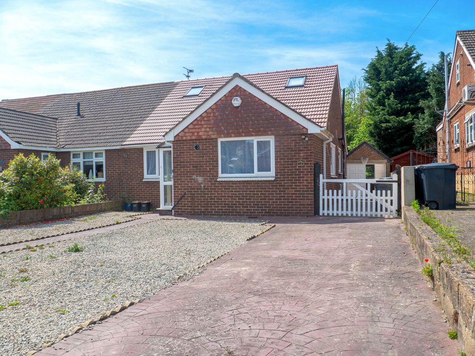 A house with a driveway and garden at Cozy Riverside Retreat in Snodland