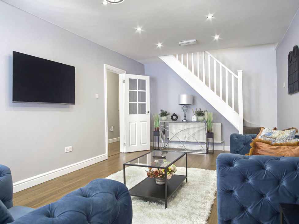 A living room with a television and sofas at Cozy Riverside Retreat in Snodland