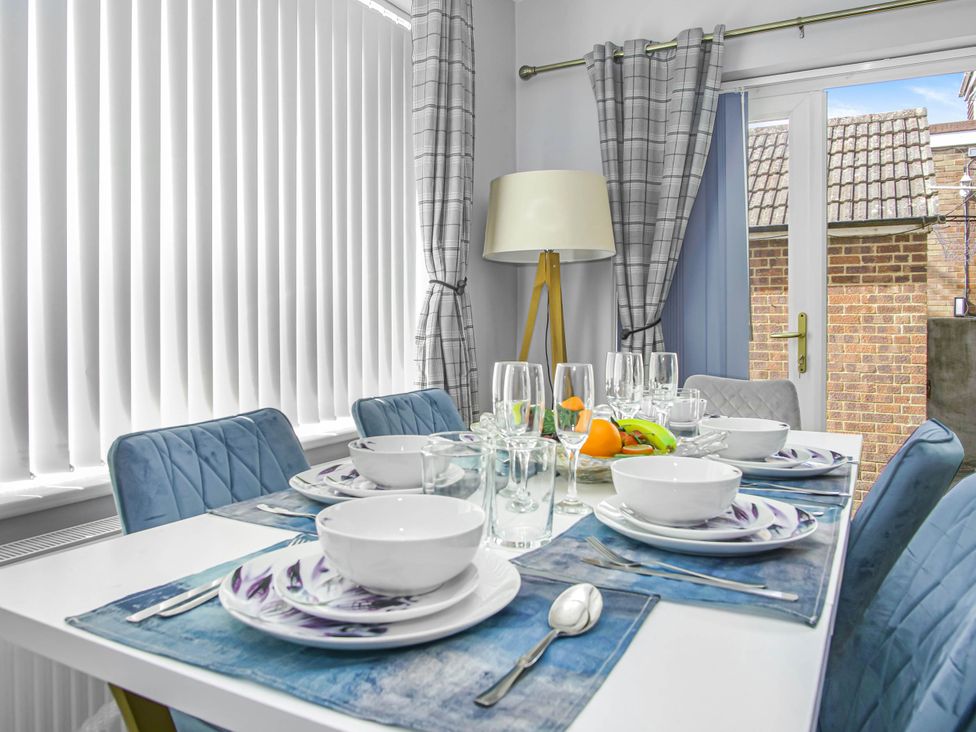 A dining room with a table set for meals at Cozy Riverside Retreat in Snodland
