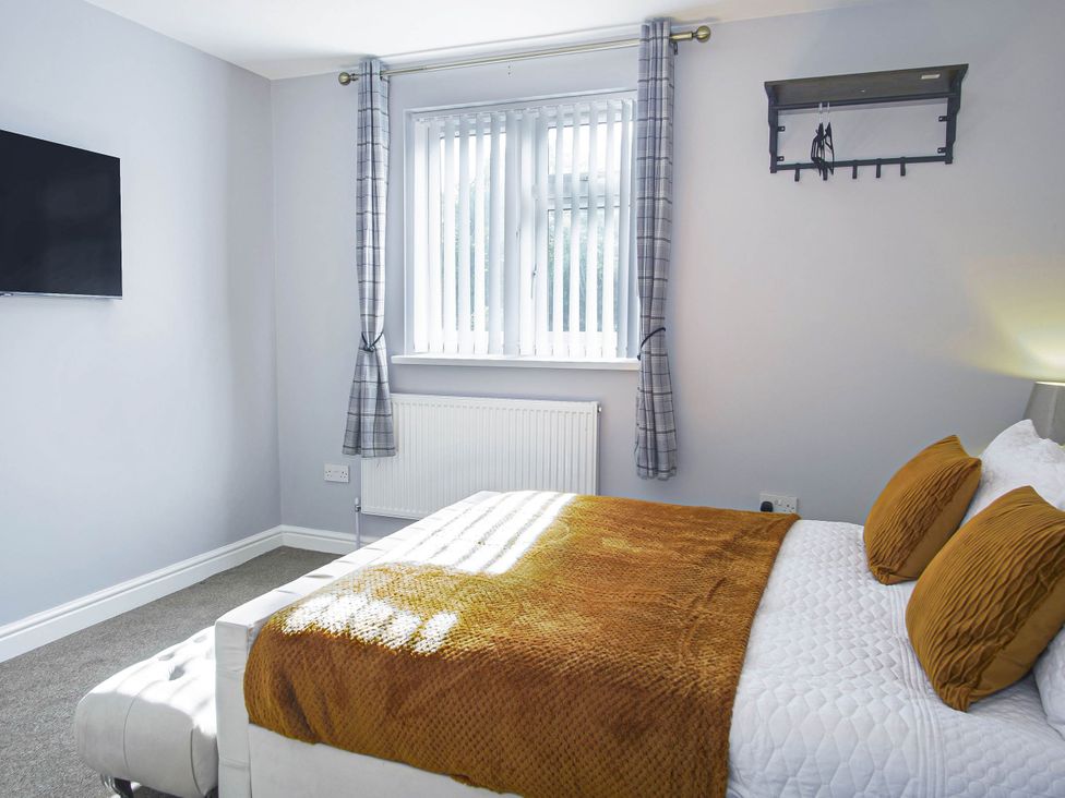 A bedroom with a bed and television at Cozy Riverside Retreat in Snodland