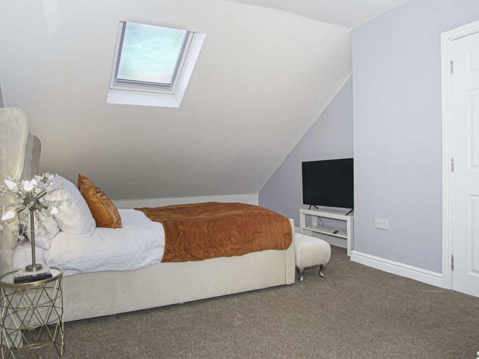 A bedroom with a bed and television at Cozy Riverside Retreat in Snodland