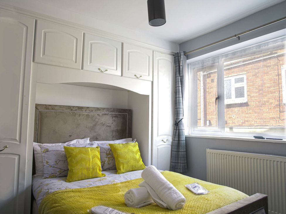 A bedroom with a bed and window at Cozy Riverside Retreat in Snodland