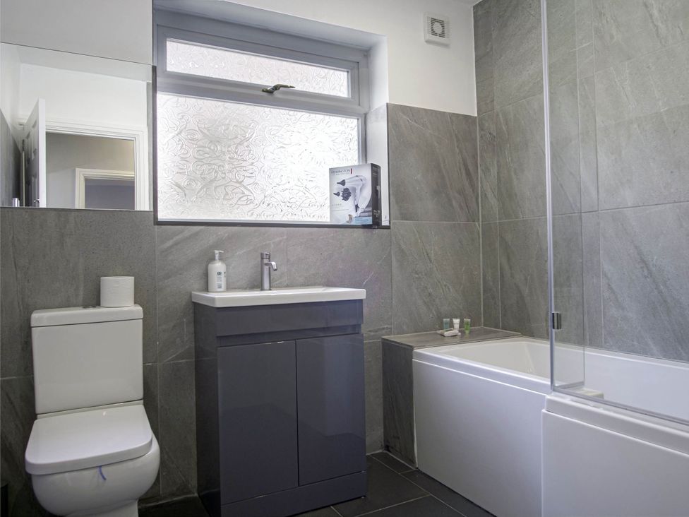 A bathroom with a sink and toilet at Cozy Riverside Retreat in Snodland