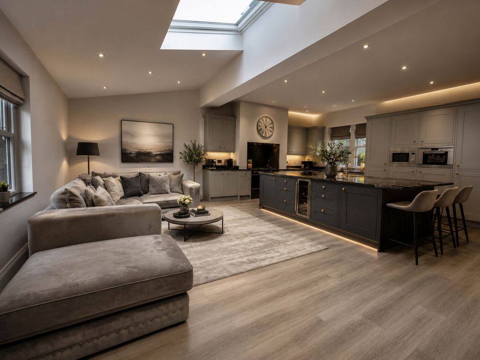 A living room with a sofa and kitchen island at Chowdene Lodge Estate