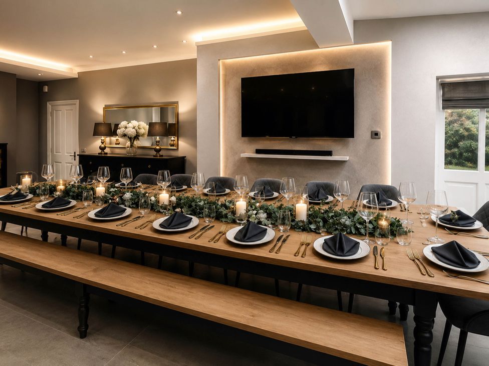 A dining room with a long table set for a meal at Chowdene Lodge Estate