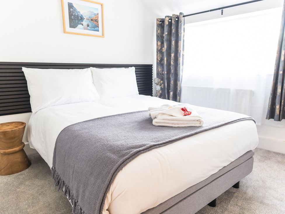 A bedroom with a bed and towels on a blanket at The Old Barn in Manchester
