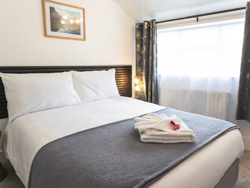 A bedroom with a double bed and decorative elements at The Old Barn in Manchester