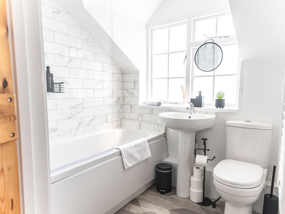 A bathroom with a bathtub, sink, and toilet at 