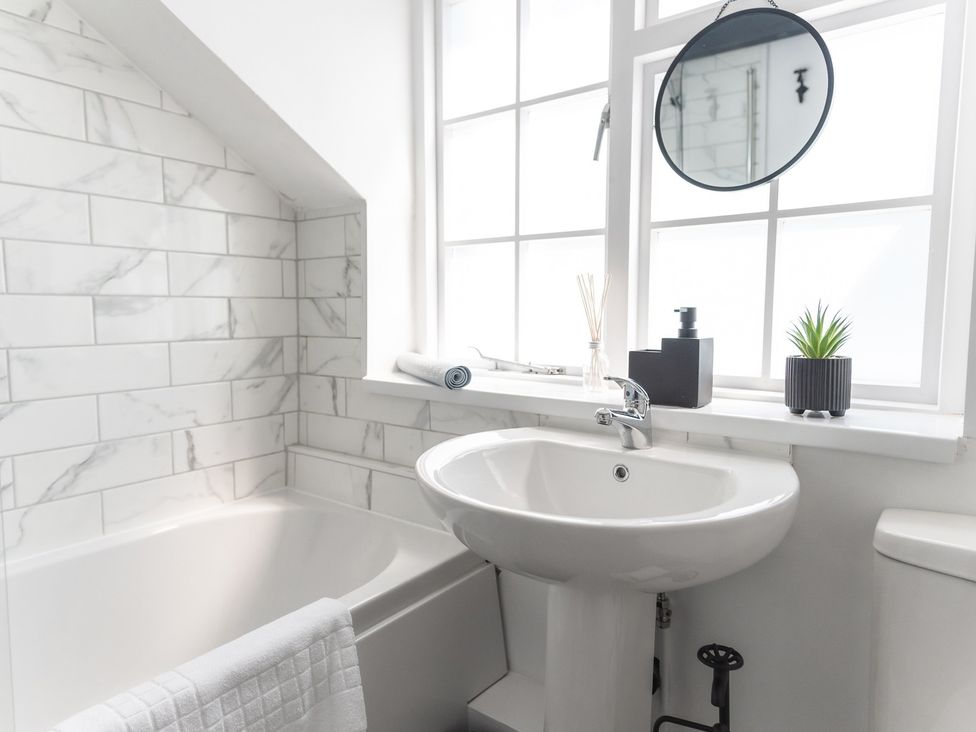 A bathroom with a sink and bathtub at a property