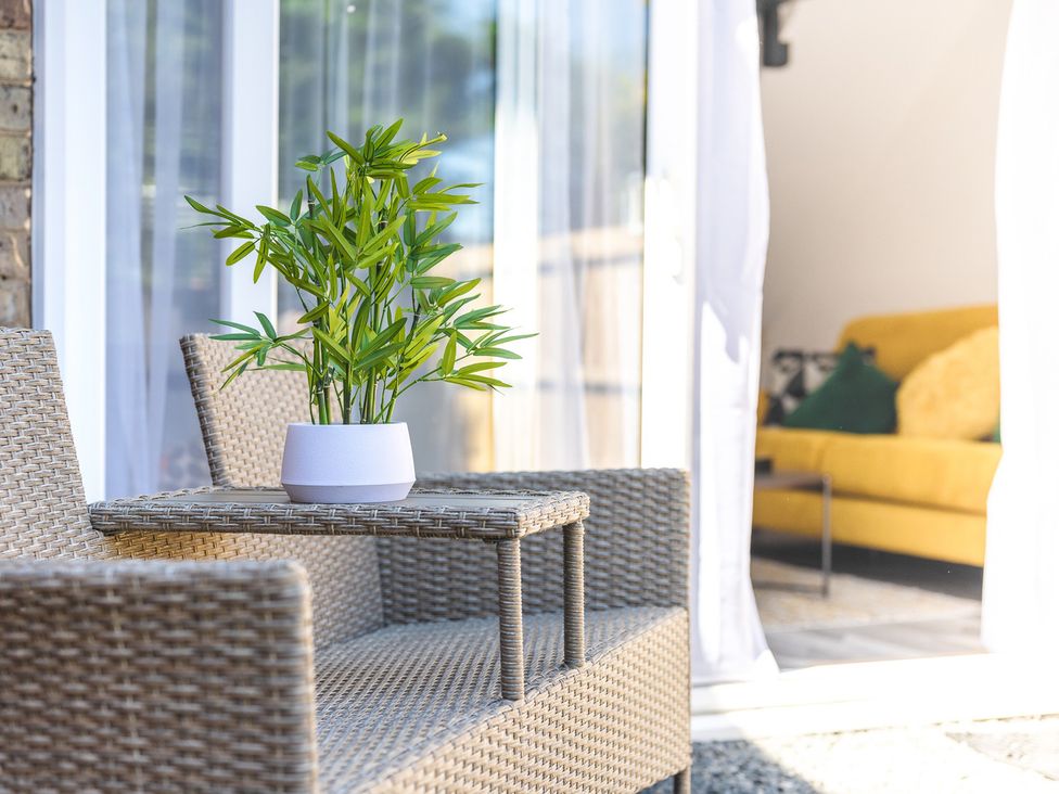 An outdoor seating area with chairs and a table at 