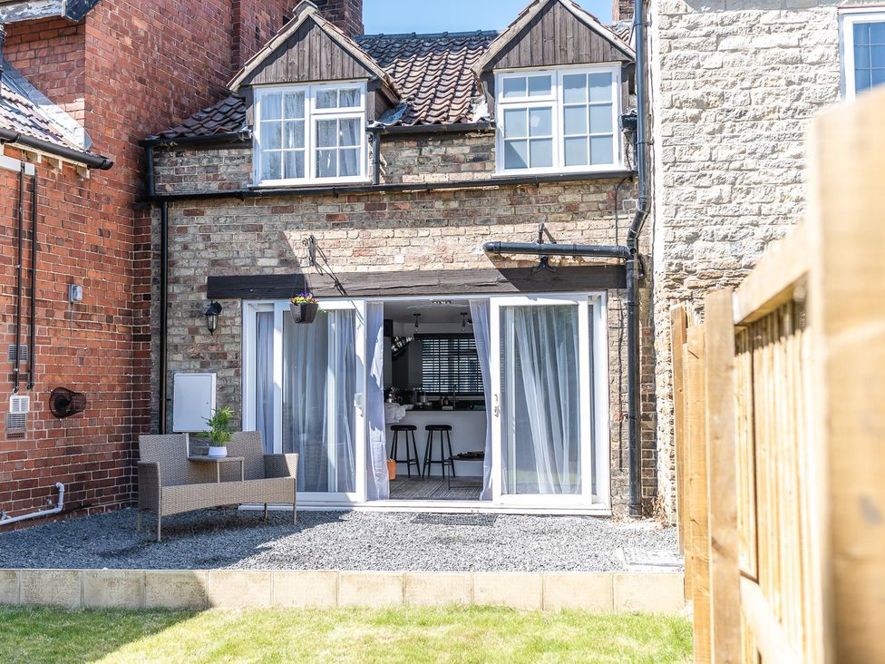 A backyard with sliding doors and seating area at the property in England