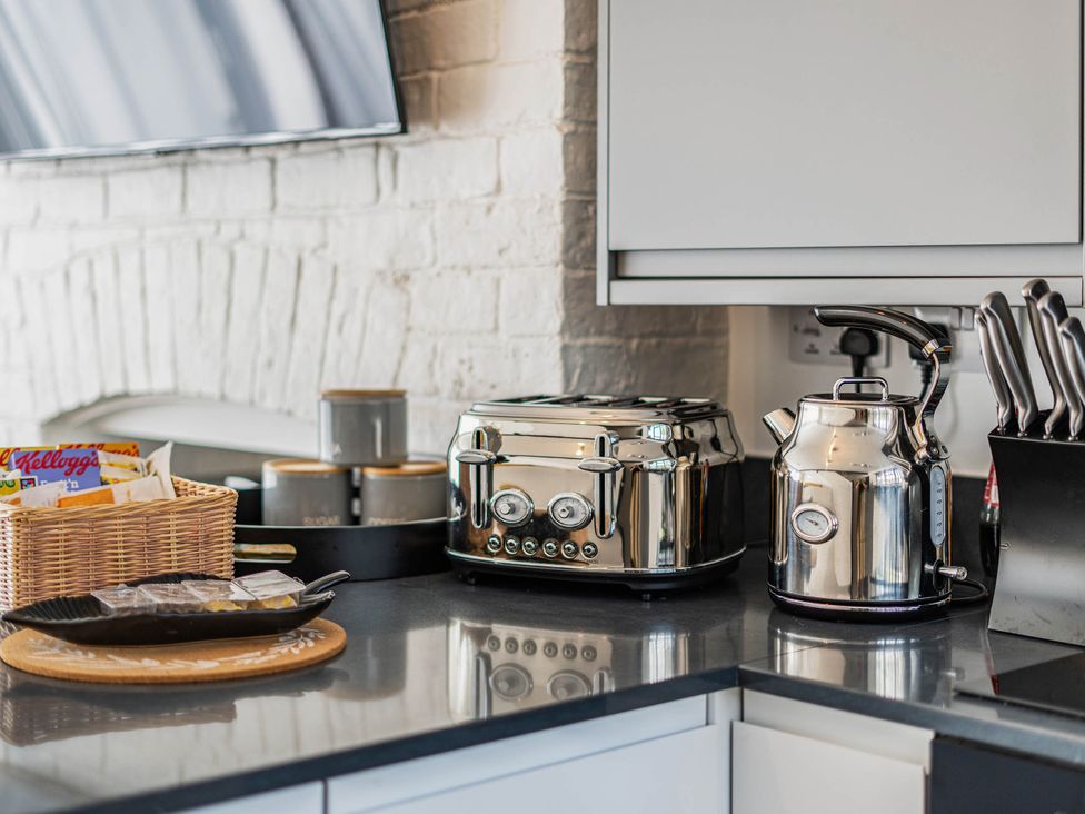 A kitchen with a toaster and kettle at Captivating 2 Bed House in Nettleham