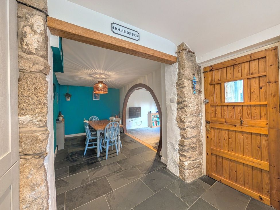A dining area with a table and chairs at The Old Barn near St Ives Rustic Charm Space Lelant