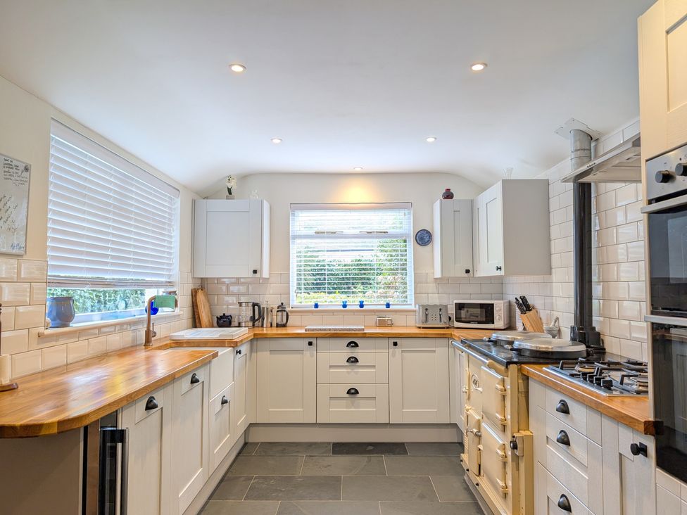 A kitchen with cabinets and stove at The Old Barn near St Ives Rustic Charm Space, Lelant